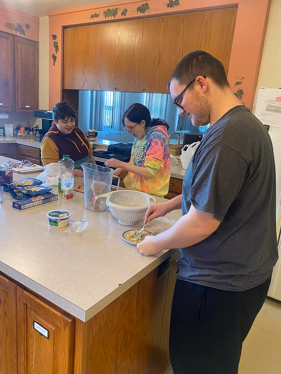 Members of the Foods 1 class preparing lunch together at a kitchen counter