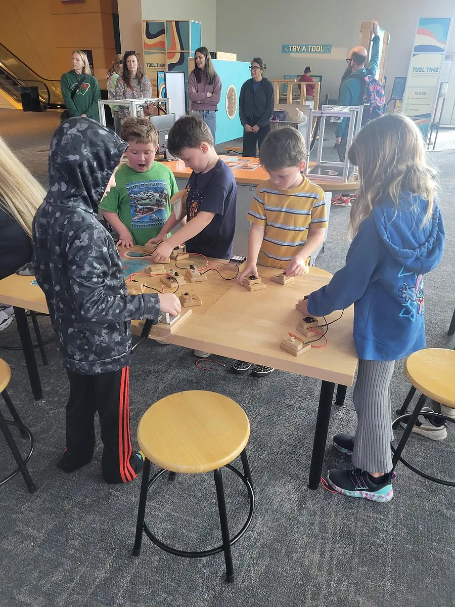 Main Street School students working together around a hands-on workshop table