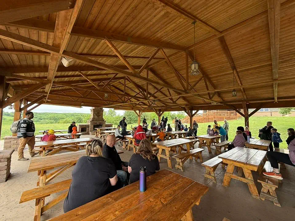 Main Street School students and adults gathered under a picnic shelter during a field trip