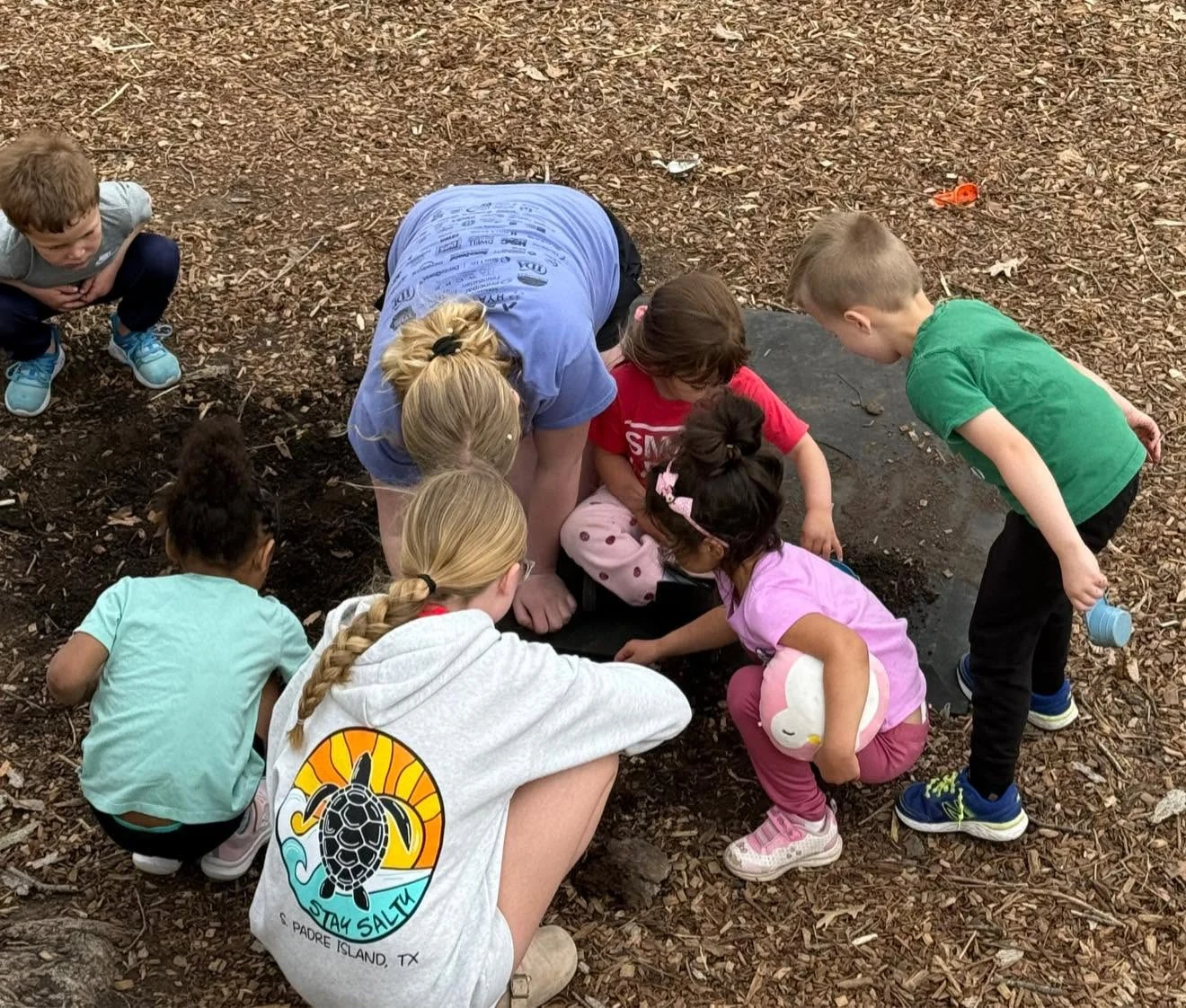 Main Street School students gathered around an outdoor discovery activity