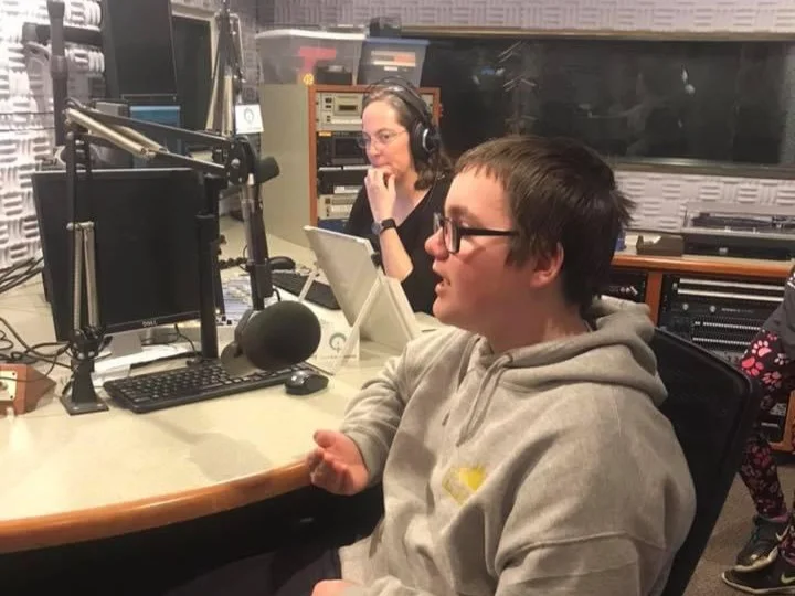 A Main Street School middle school student recording a community history project at a radio studio